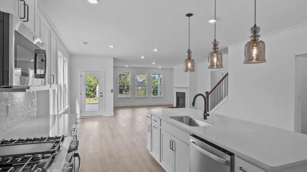 Elegant kitchen featuring a 9-foot island with pendant lighting and tasteful finishes throughout Elegant kitchen featuring a 9-foot island with pendant lighting and tasteful finishes throughout
