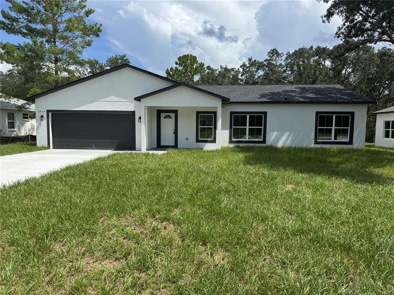 Front exterior of a new home in , Dunnellon, FL, highlighting curb appeal (Image 2).