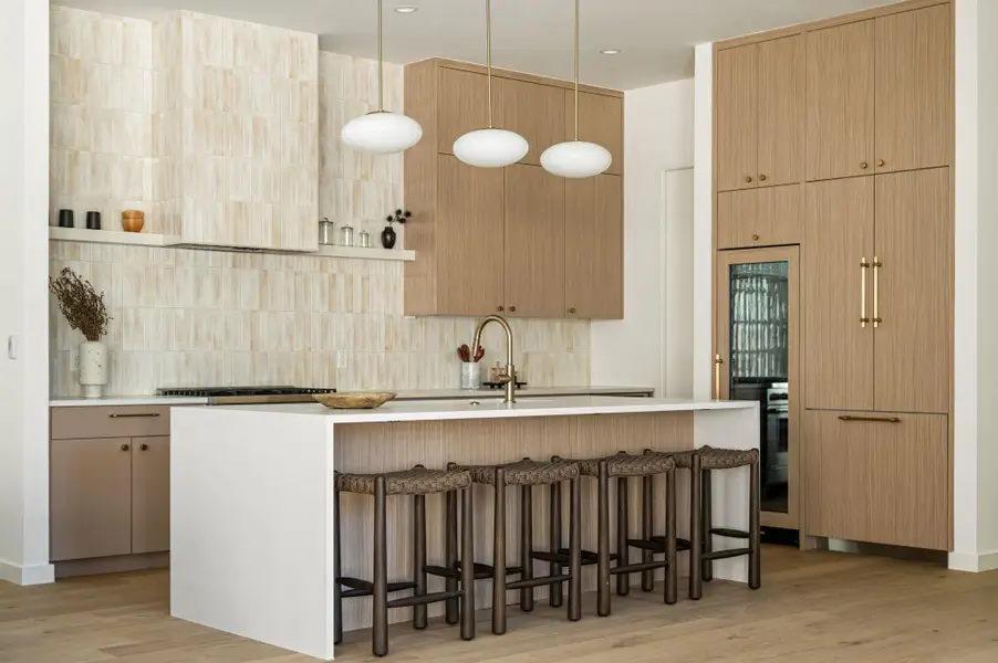 Minimalist cabinetry and custom tiling frame this refined culinary workspace.