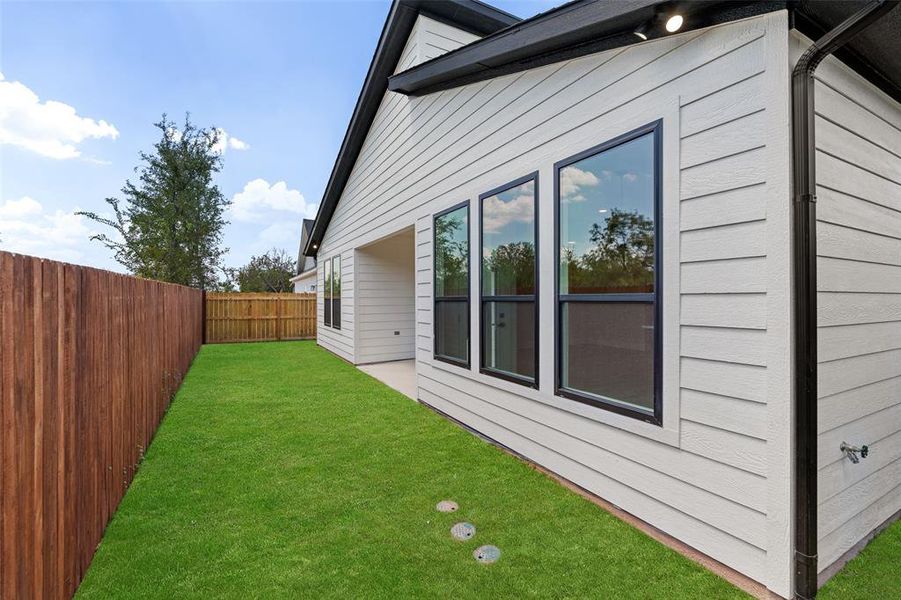 View of side of home featuring a lawn