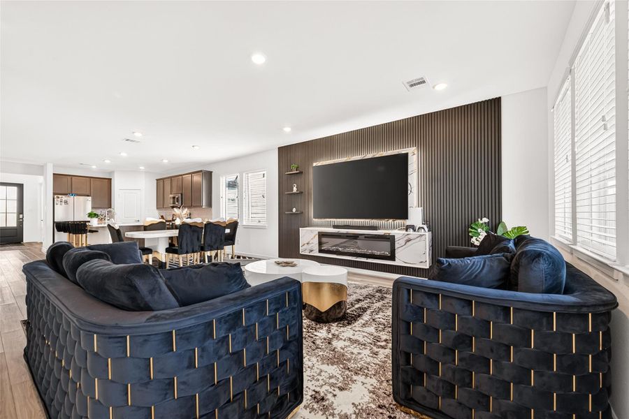 Spacious open-concept living and dining area designed for both everyday comfort and entertaining. Featuring luxury vinyl plank flooring, recessed lighting, and seamless flow into the kitchen, this inviting space offers a modern aesthetic with versatile layout options