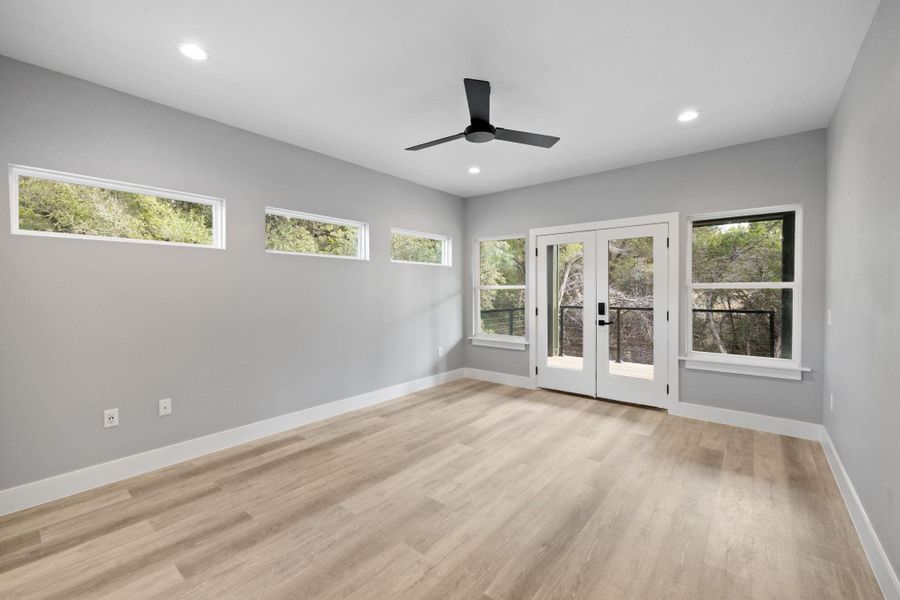 Primary bedroom has access to the back porch and plenty of light.