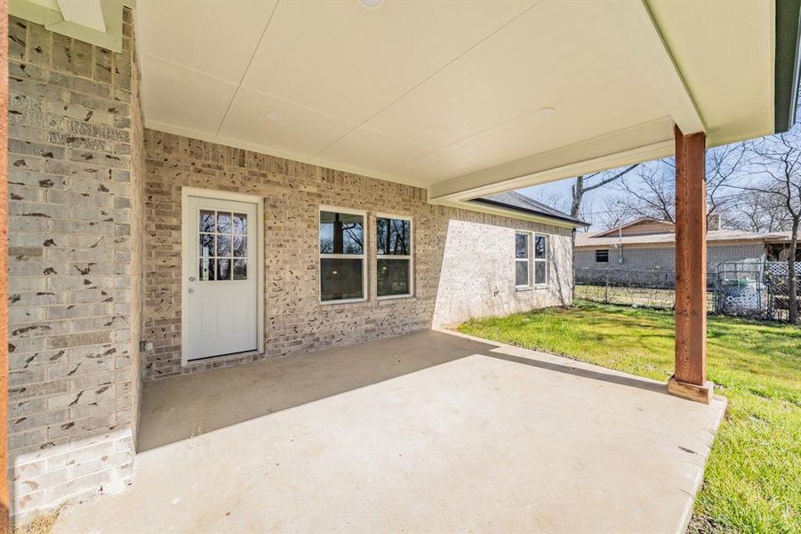 View of patio featuring fence