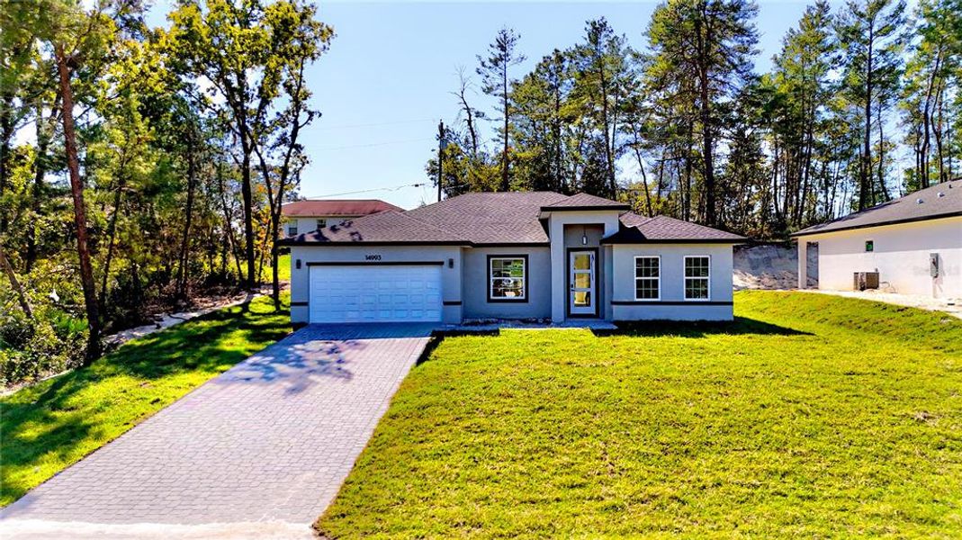 Front exterior of a new home in , Ocala, FL, highlighting curb appeal (Image 1).