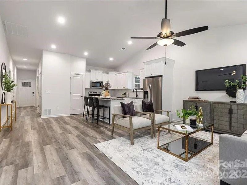 staged family room view to kitchen