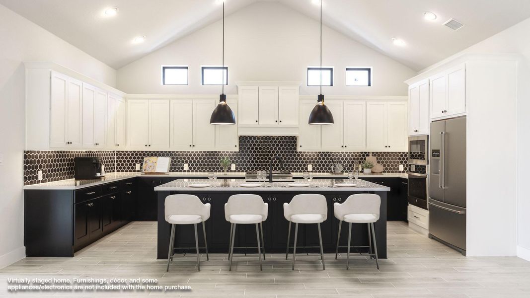 Kitchen with dark cabinetry, pendant lighting, white cabinetry, high vaulted ceiling, and a kitchen bar