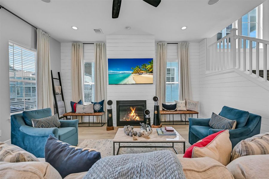 High ceilings, natural light, shiplap details, and expansive windows make the main living area feel open and connected. This is the kind of space buyers instantly picture hosting in.