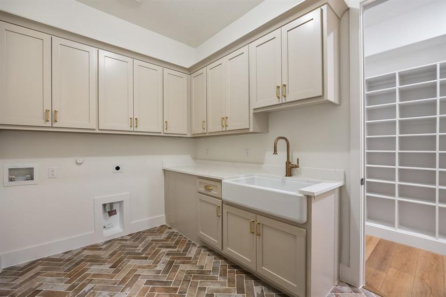 Laundry room featuring hookup for a gas dryer, hookup for an electric dryer, hookup for a washing machine, and cabinet space