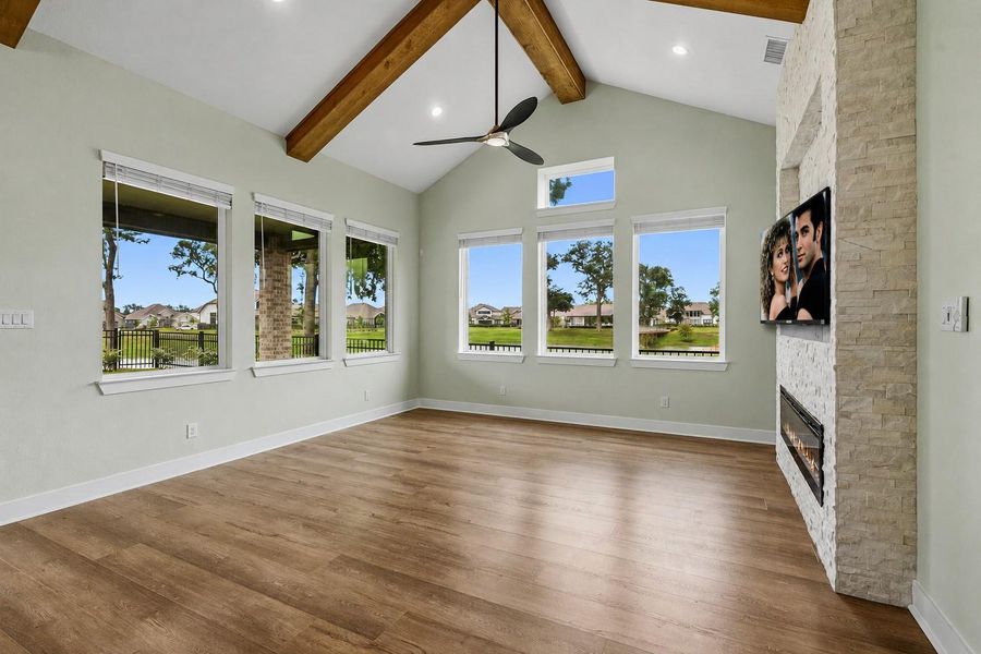 The stunning Family Room is drenched in natural light, thanks to six expansive picture windows topped by a transom window that enhances the sense of openness and grandeur. Framing breathtaking panoramic views of Sheffield Lake, this inviting space seamlessly connects the indoors with the natural beauty beyond, creating a serene and picturesque backdrop for both everyday living and entertaining.