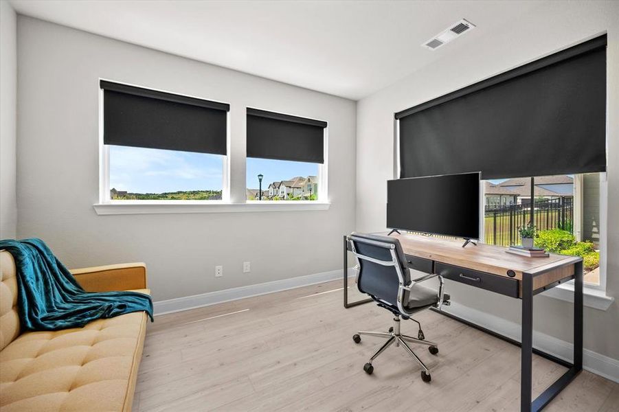 Office space featuring healthy amount of natural light and wood finished floors Office space featuring healthy amount of natural light and wood finished floors