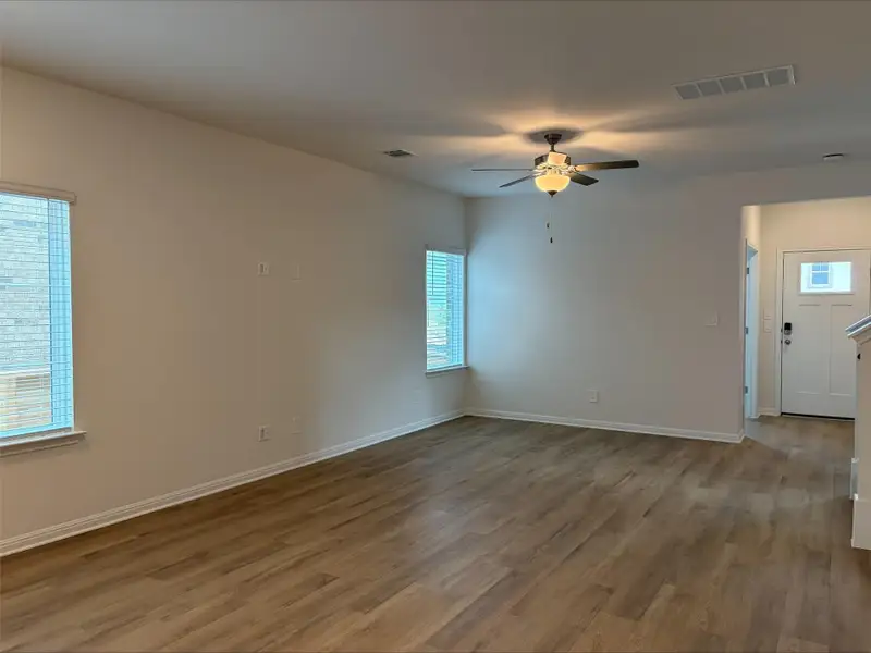 Spare room featuring light wood-style floors and a ceiling fan