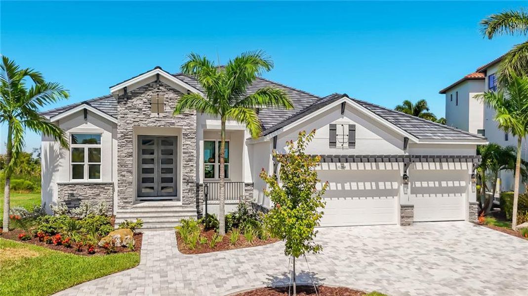 Front exterior of a new home in Legends Bay, Bradenton, FL, highlighting curb appeal (Image 26). Front exterior of a new home in Legends Bay, Bradenton, FL, highlighting curb appeal (Image 26).