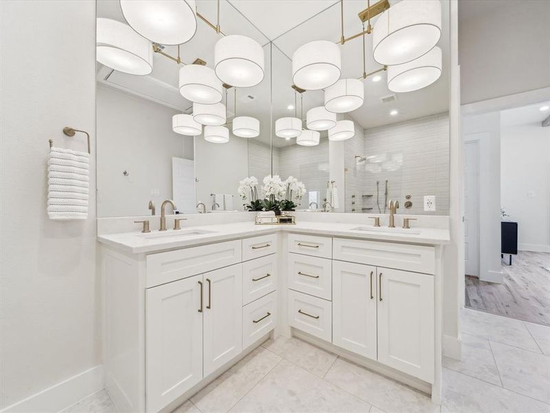 Bathroom with tile patterned floors, vanity, and tiled shower