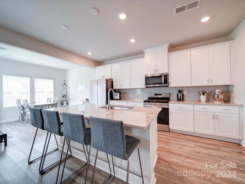 KITCHEN ISLAND/KITCHEN - Offers Granite Counters, Large Kitchen Island with seating for up to 4.  Gas Stove and Built-In Microwave.