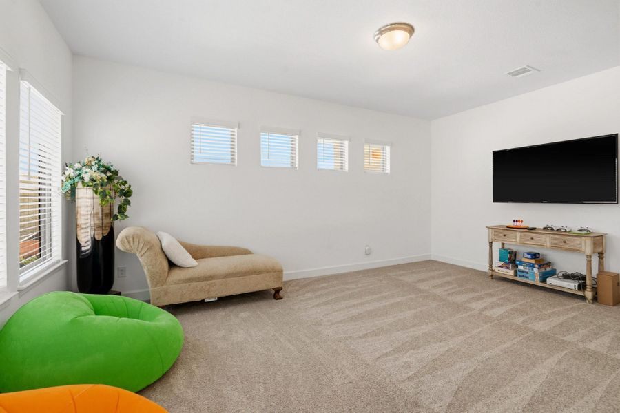 Bright and spacious family room with soaring ceilings, abundant natural light, and an open-concept layout