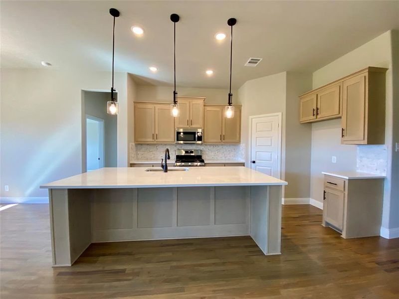 Island has cabinet color visible from all sides like a custom furniture piece