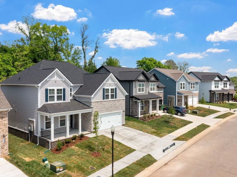 Front exterior of a new home in Woods Crossing, Gallatin, TN, highlighting curb appeal (Image 2). Front exterior of a new home in Woods Crossing, Gallatin, TN, highlighting curb appeal (Image 2).