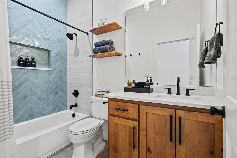 Bathroom featuring vanity and shower / bath combo with shower curtain