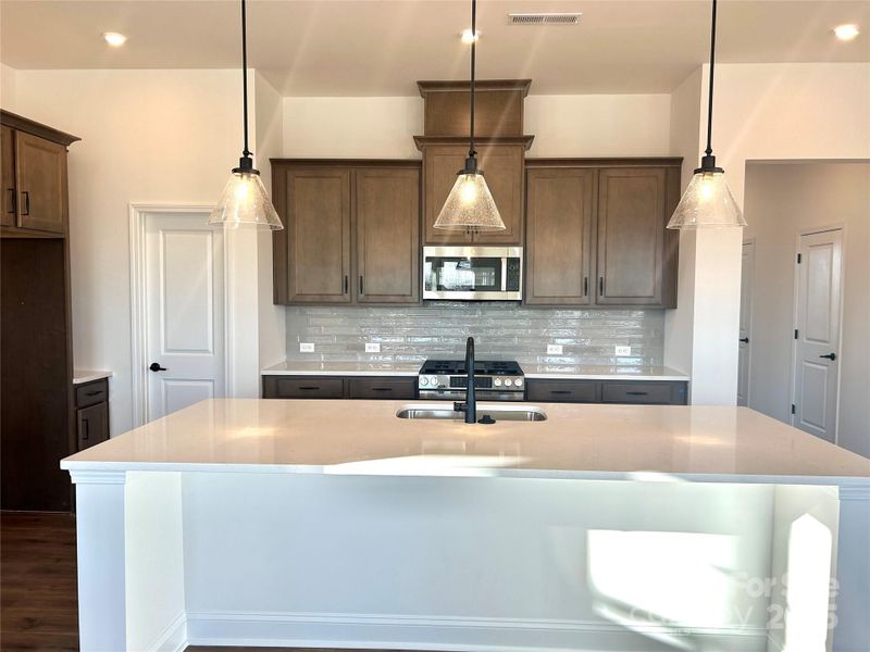Massive quartz countertop island...great for entertaining. Massive quartz countertop island...great for entertaining.