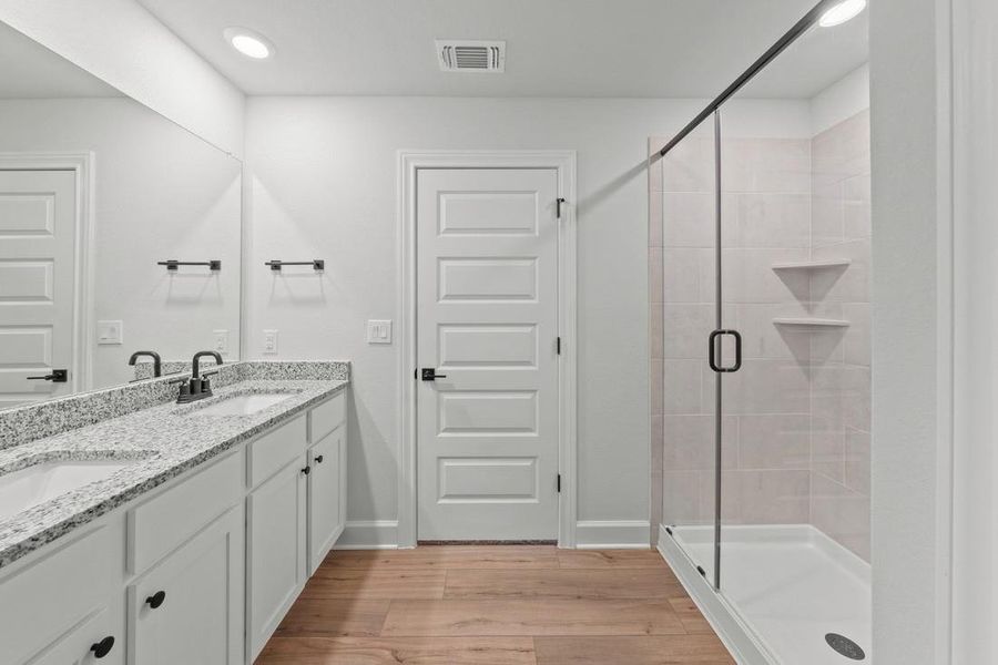The primary bath is truly impressive, boasting modern fixtures, a spacious walk-in closet and all the amenities needed for relaxation and pampering.