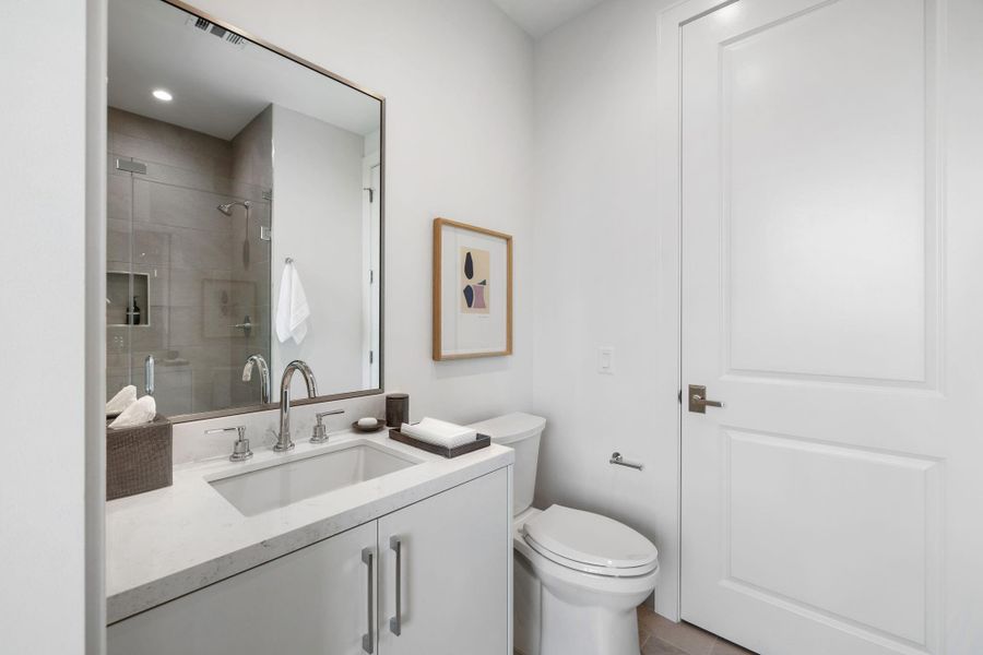 En-suite secondary guest bathroom with walk-in shower and beautiful quartz counter-top