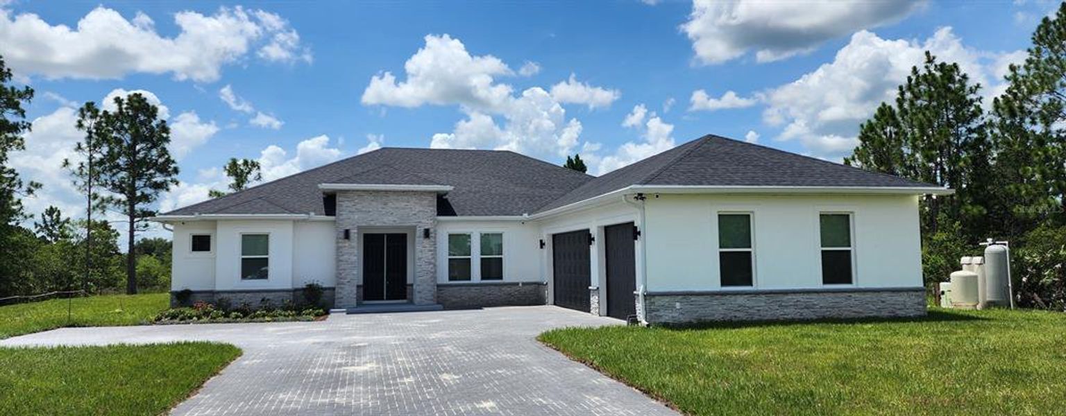 Front exterior of a new home in , Oviedo, FL, highlighting curb appeal (Image 2).