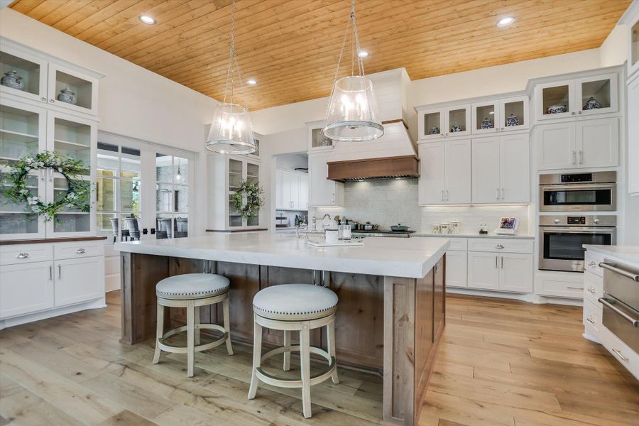 Kitchen featuring wooden ceiling, light countertops, white cabinets, recessed lighting, and backsplash Kitchen featuring wooden ceiling, light countertops, white cabinets, recessed lighting, and backsplash