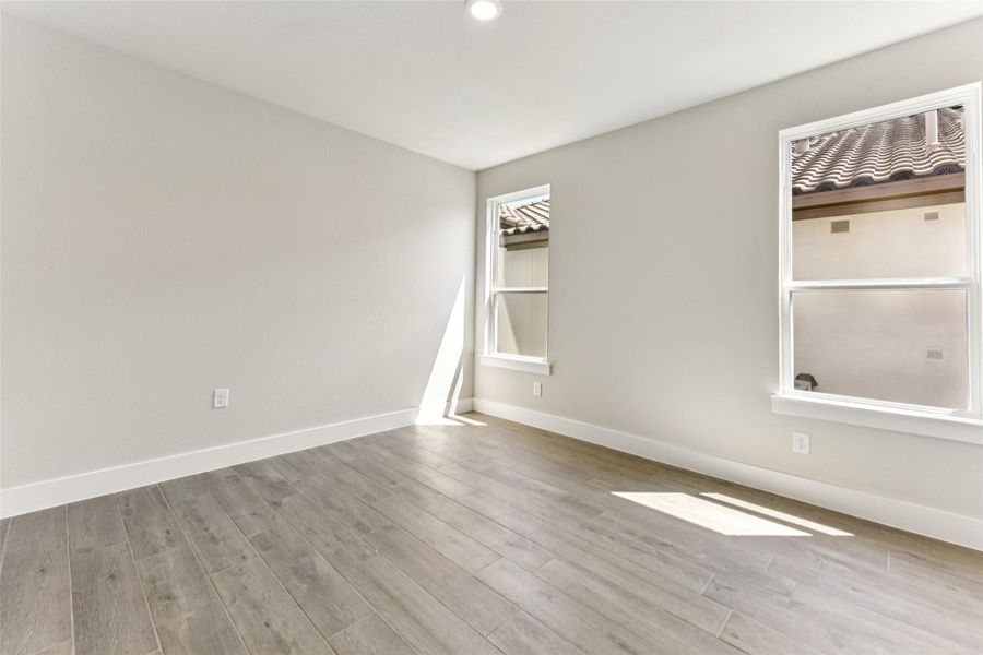 Unfurnished room with light wood finished floors and recessed lighting Unfurnished room with light wood finished floors and recessed lighting