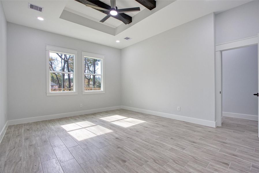 Large primary bedroom with lovely ceiling detail. Large primary bedroom with lovely ceiling detail.