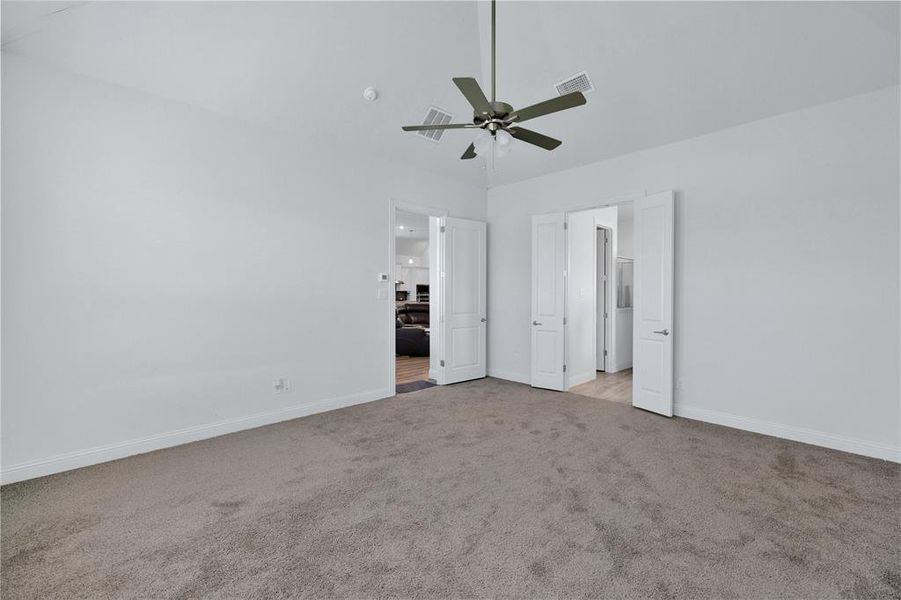Unfurnished bedroom featuring light colored carpet and ceiling fan