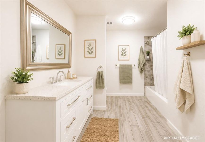 Contemporary bathroom featuring a spacious white vanity with ample storage, a light-toned countertop, and a large framed mirror