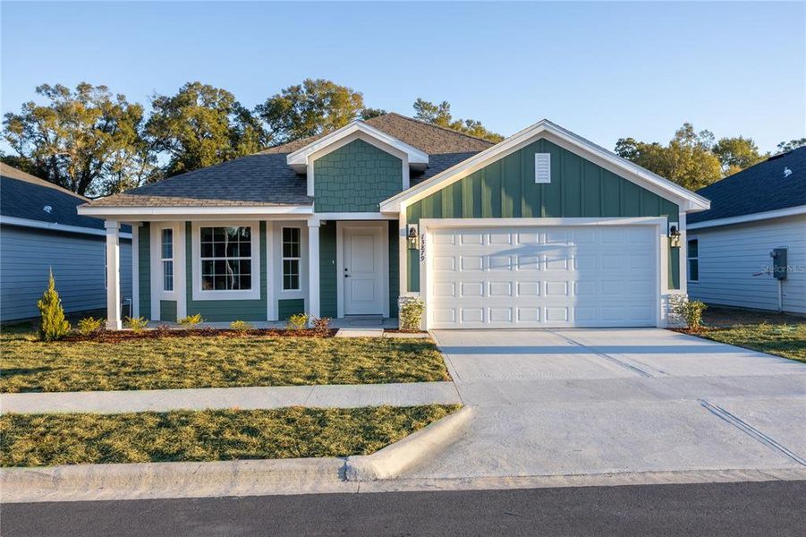 Front exterior of a new home in Briarwood, Alachua, FL, highlighting curb appeal (Image 18).