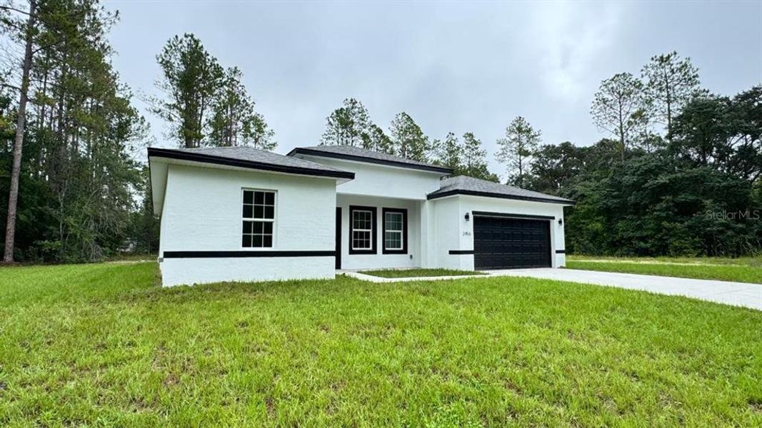 Front exterior of a new home in , Citrus Springs, FL, highlighting curb appeal (Image 17).