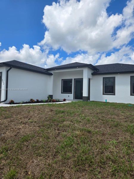 Front exterior of a new home in , Lehigh Acres, FL, highlighting curb appeal (Image 21). Front exterior of a new home in , Lehigh Acres, FL, highlighting curb appeal (Image 21).