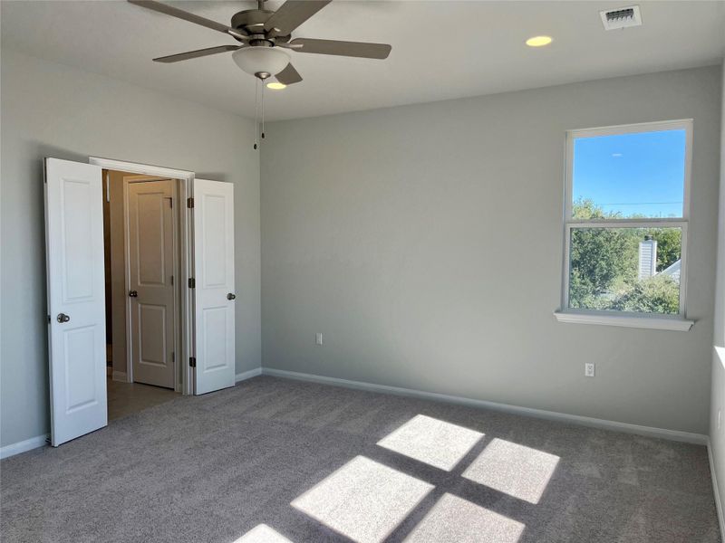Unfurnished bedroom with carpet, a ceiling fan, and recessed lighting