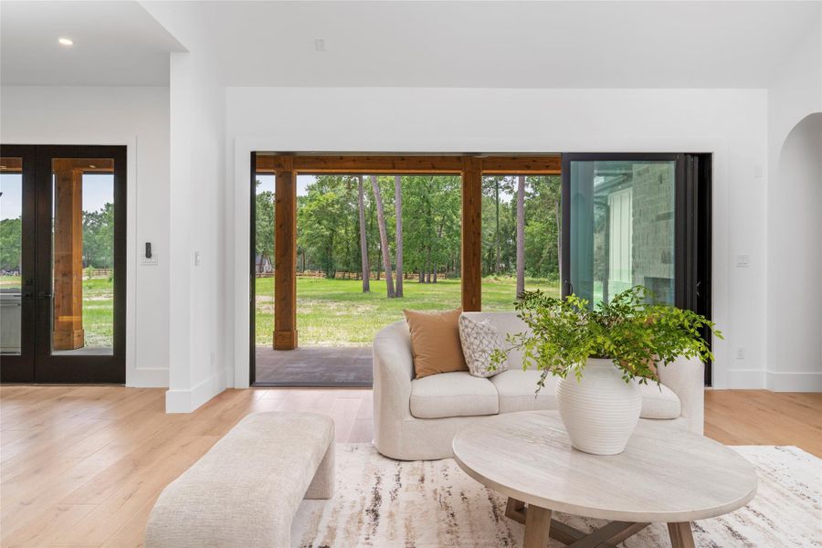 16’ sliding glass doors + rear French doors with full backyard views 16’ sliding glass doors + rear French doors with full backyard views