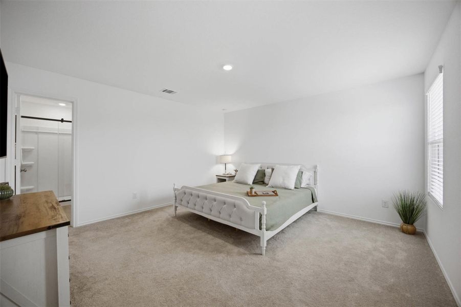 Recessed lighting and wall-to-wall carpeting define this peaceful private retreat.
