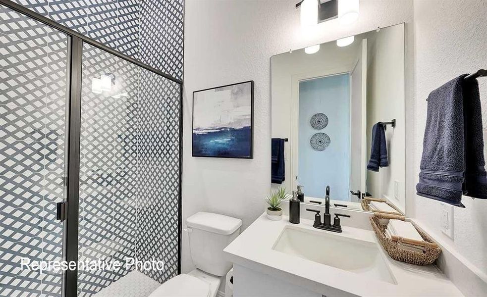 Modern bathroom featuring a glass-enclosed shower with geometric patterned tile