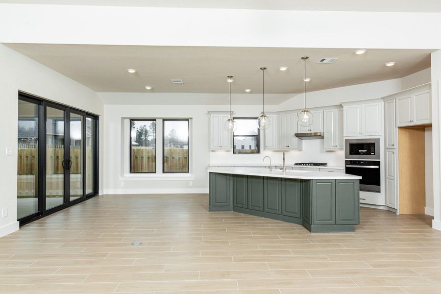 Create lasting memories around the table with family and friends in the dining! It showcases high ceilings, large windows, tile flooring, and recessed lighting for a warm and welcoming atmosphere.