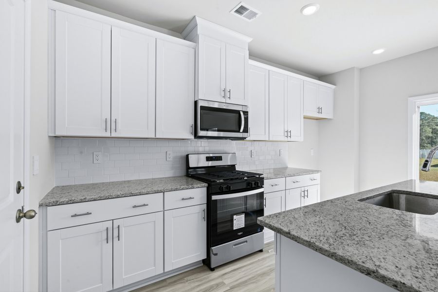 The well-appointed kitchen features plenty of counter space to make meal prep a breeze. The well-appointed kitchen features plenty of counter space to make meal prep a breeze.