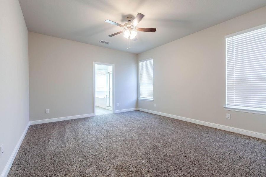 Unfurnished room featuring carpet flooring and a ceiling fan Unfurnished room featuring carpet flooring and a ceiling fan