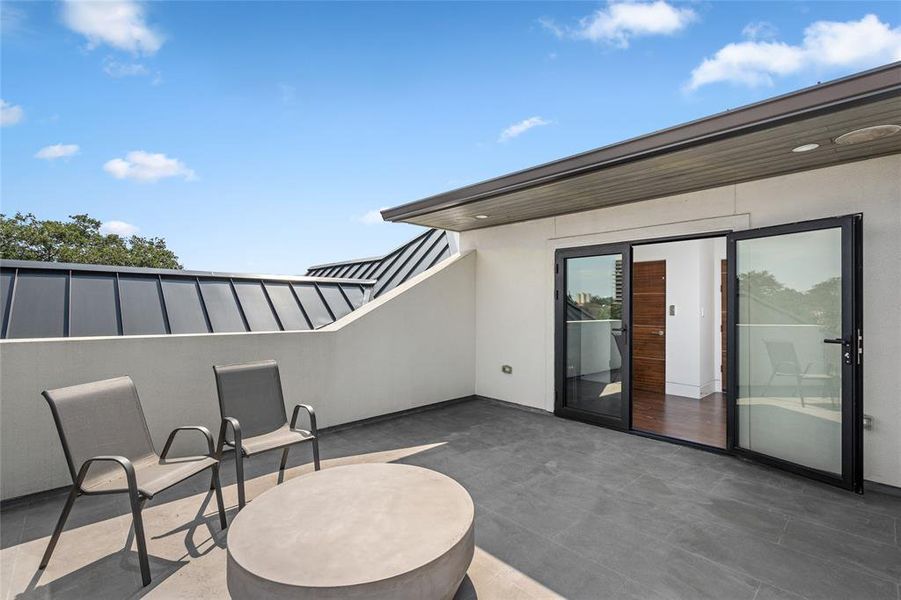 This third-floor rooftop patio offers breathtaking views and plenty of space for outdoor entertaining or relaxing. With sleek tile flooring and covered ceiling detail, this patio is perfect for enjoying fresh air and panoramic views.