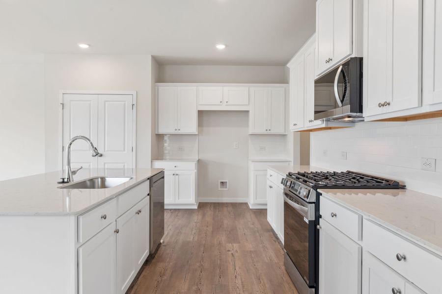 A kitchen with white cabinets. A kitchen with white cabinets.