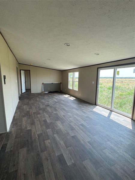 Sliding glass doors open to open pasture views from this versatile main living area.