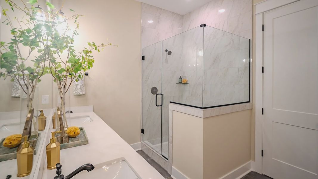 Primary bathroom with dual vanity and glass enclosed shower Primary bathroom with dual vanity and glass enclosed shower