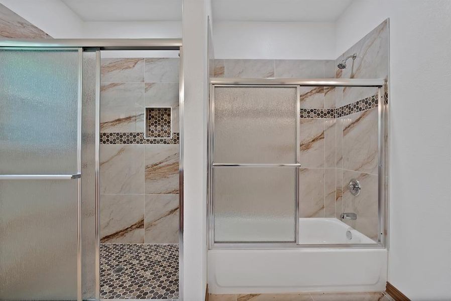 Full bath with combined bath / shower with glass door