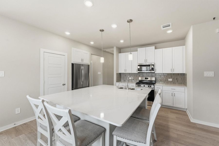 Kitchen has a nice size pantry and tons of storage. See how the added cabinets above the Fridge gives a sleek cohesive look to the space. No mess or stacks on top of the fridge. The seller also added functional windows in place of the builders solid glass choice in the Kitchen area taking this home from cookie cutter to Custom! Kitchen has a nice size pantry and tons of storage. See how the added cabinets above the Fridge gives a sleek cohesive look to the space. No mess or stacks on top of the fridge. The seller also added functional windows in place of the builders solid glass choice in the Kitchen area taking this home from cookie cutter to Custom!