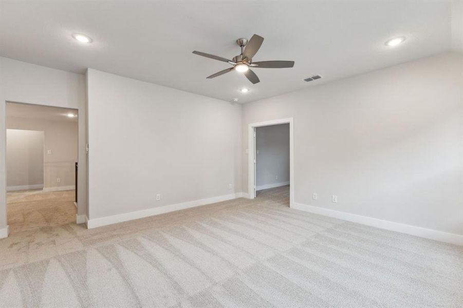 Spare room with light colored carpet, a ceiling fan, and recessed lighting