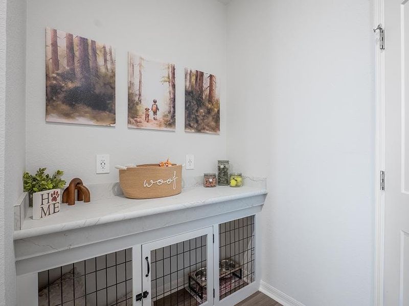 A mudroom with a drop zone counter and coat closet is located at the garage entry - Monroe by Highland Homes