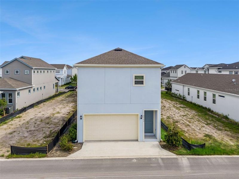 Front exterior of a new home in Laureate Park, Orlando, FL, highlighting curb appeal (Image 31).